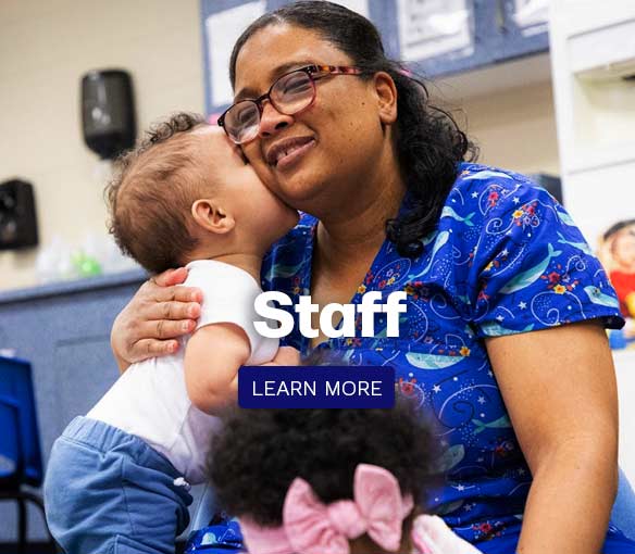 a photo of a staff member with an infant